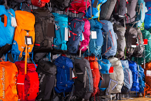 backpacks, helmets and other sports equipment in the sports shop