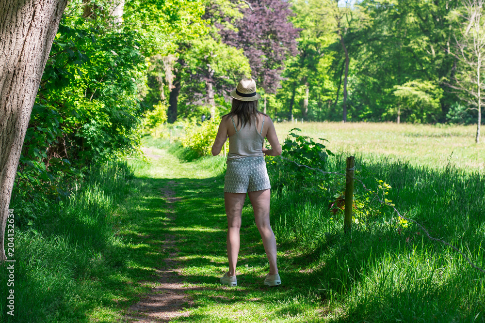 Happy portrait of a women on a beautiful sunny day in a green forest in the summer Happy portrait of a women on a beautiful sunny day in a green forest in the summer