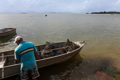 A fisherman prepares his boat to work on oyster farm.