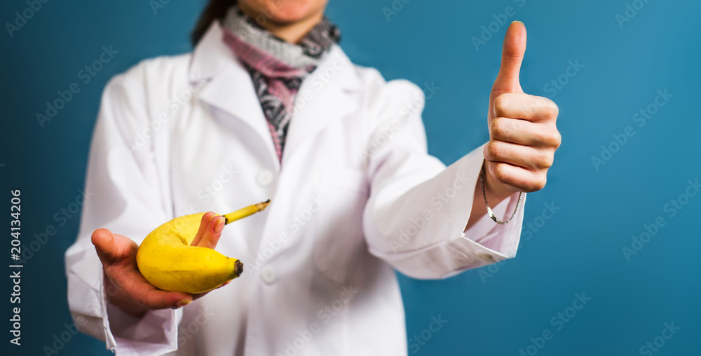 Doctor holding a banana close up