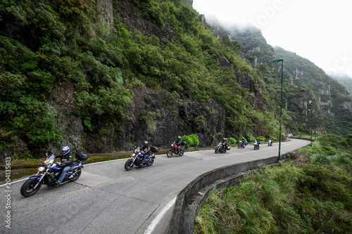 Speedy motorcycles on road in the mountains with beautiful landscape