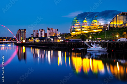 Famous Millennium bridge at night. Illuminated landmarks with river Tyne in Newcastle, UK photo