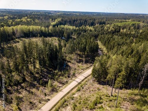 drone image. aerial view of rural area with fields and forests and gravel roads seen from above