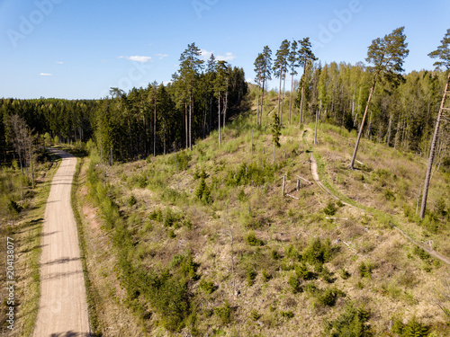 drone image. aerial view of rural area with fields and forests and gravel roads seen from above