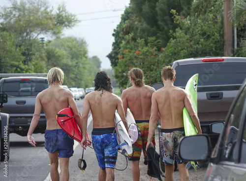 Group of young surfers at North Shore, Oahu, Hawaii