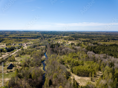 drone image. aerial view of rural area with fields and forests and gravel roads seen from above