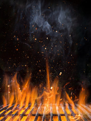 Empty flaming charcoal grill with open fire.