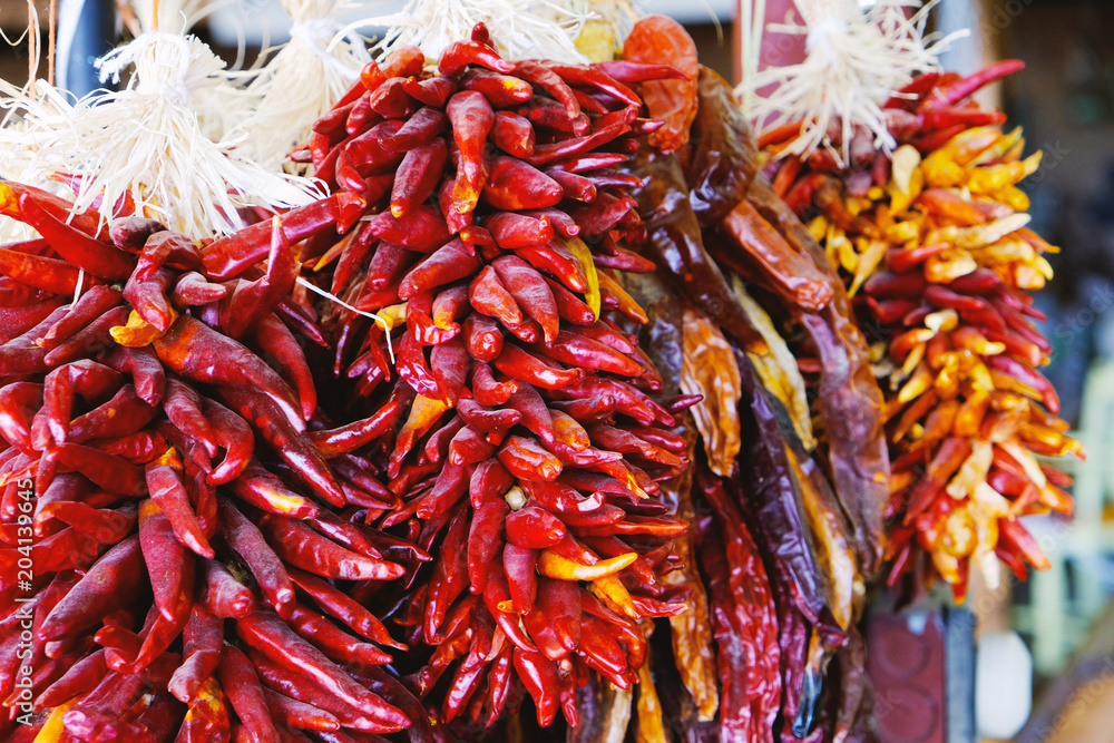 Naklejka premium Peppers hanging at public market