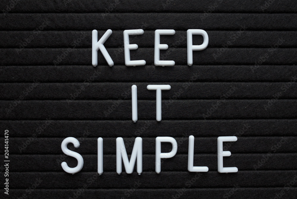 The words Keep It Simple in white plastic letters on a black letter board as a reminder for when planning your strategy The words Keep It Simple in white plastic letters on a black letter board as a reminder for when planning your strategy