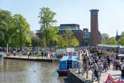 Photos large crowd of people gather in front of the RSC by the canal basin and river