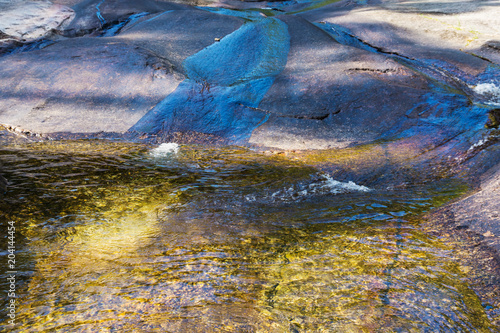 Crystal clear water in mountain lake. Mountain river flowing through rocks to lake. Langkawi island  Malaysia