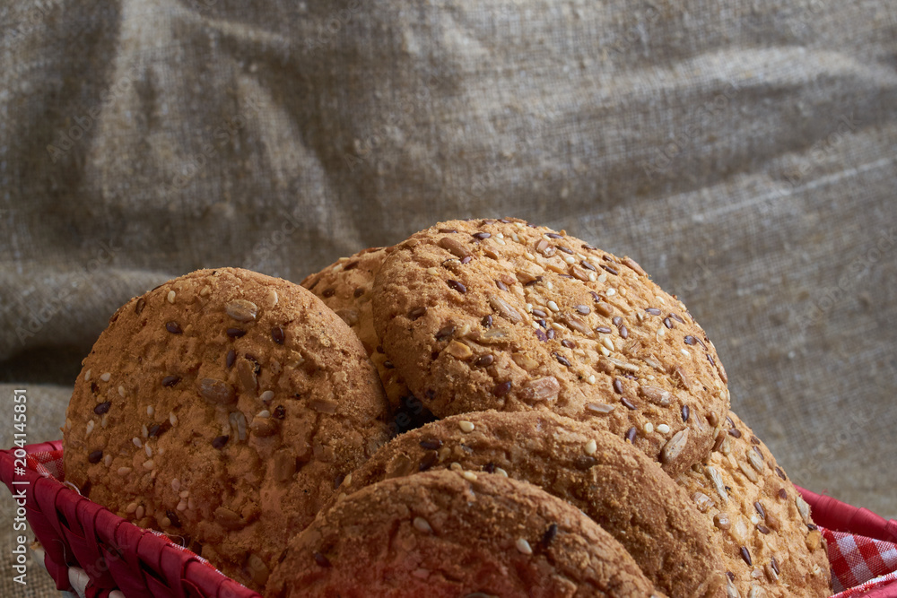 Savory cookies sprinkled with sesame seeds, sunflower on table and burlap background Savory cookies sprinkled with sesame seeds, sunflower on table and burlap background