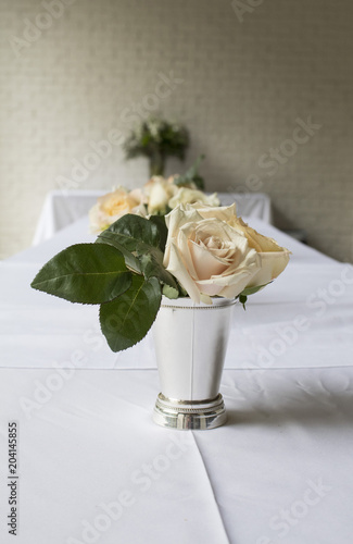Roses In Mint Julep Cup On White Linen Table