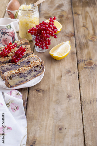 Traditional Christmas cake with lemon, nuts and berries. Delicious homemade pastries for breakfast. Place for text. Vertical photo