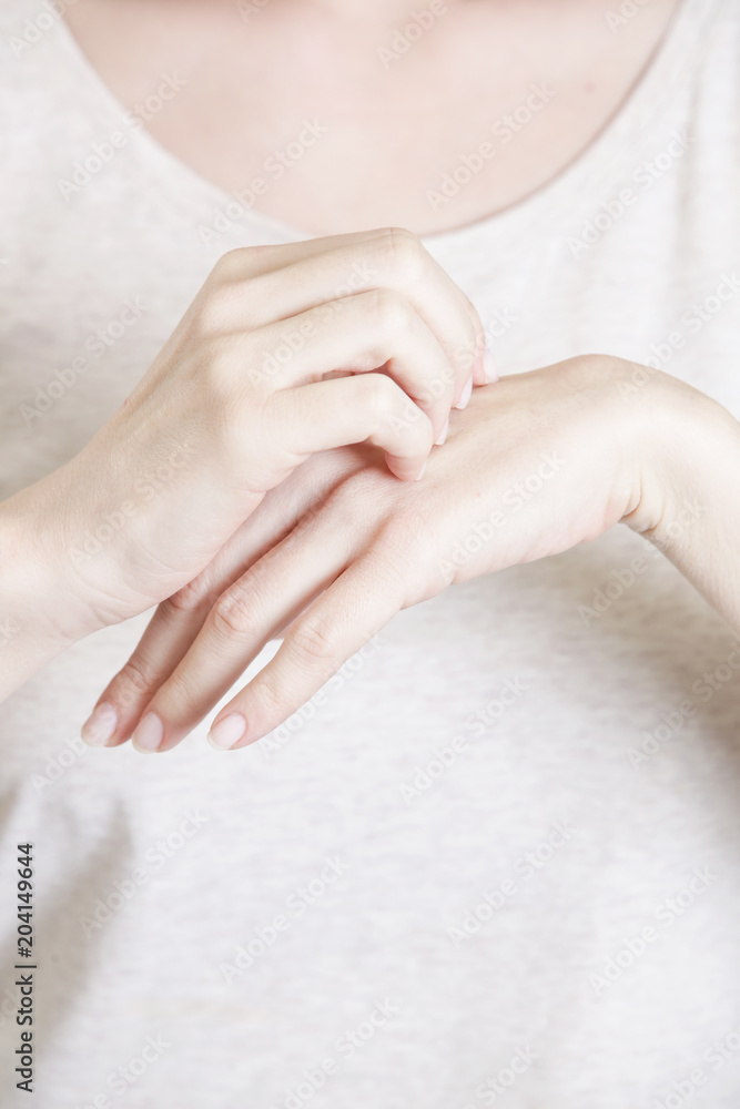 Close up of woman scratching her hand, dermatology or allergy issues
Close up of woman scratching her hand, dermatology or allergy issues