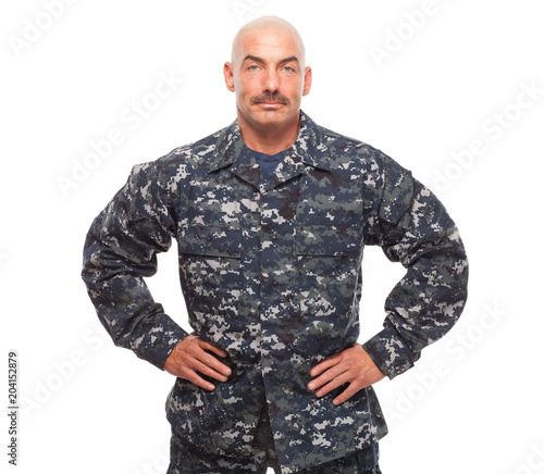 Navy sailor or chief looking serious on white background.