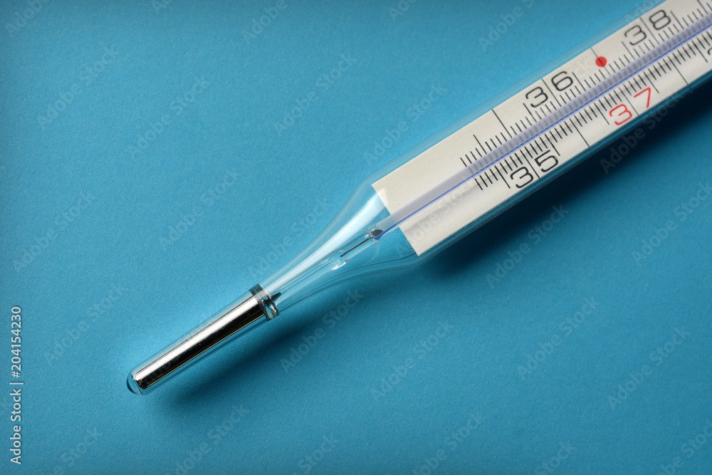 thermometer to measure body temperature on the blue background thermometer to measure body temperature on the blue background