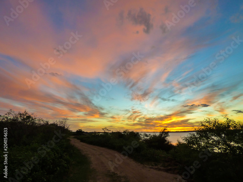 Colorful sunset by the Uruguay river at the border between Brazil and Argentina © Helissa