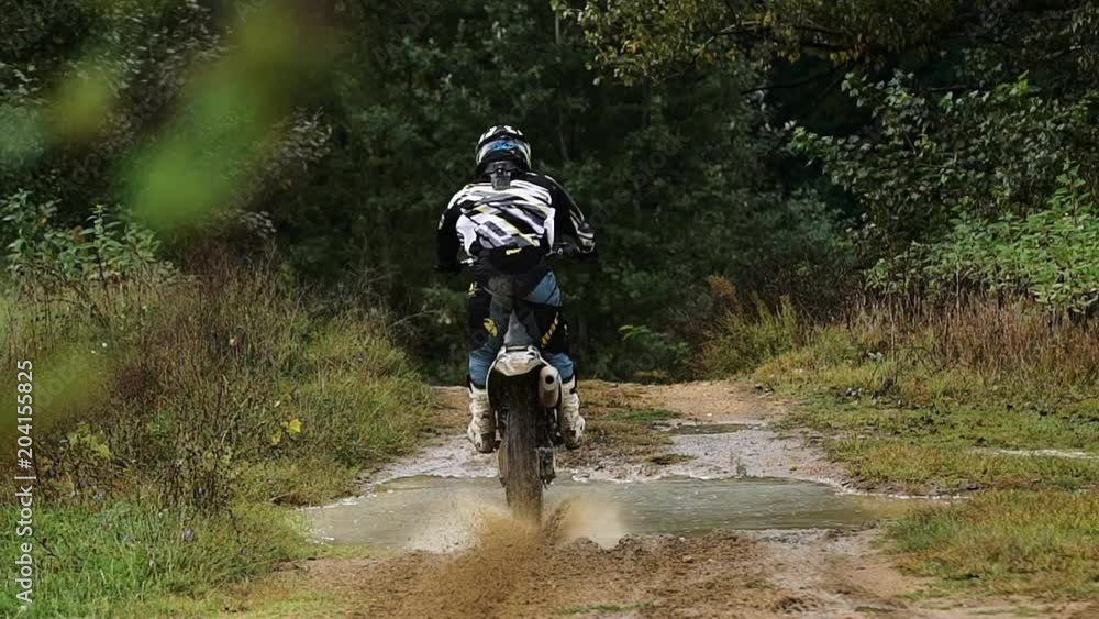 Shot of the Professional Motocross Driver Riding on His FMX Motorcycle on the Extreme Off-Road Track 4k Shot of the Professional Motocross Driver Riding on His FMX Motorcycle on the Extreme Off-Road Track 4k