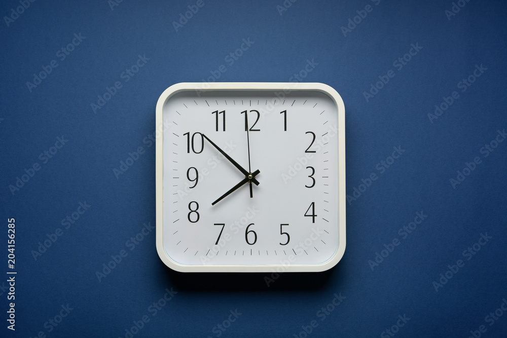 Fototapeta premium wall clock on the blue background