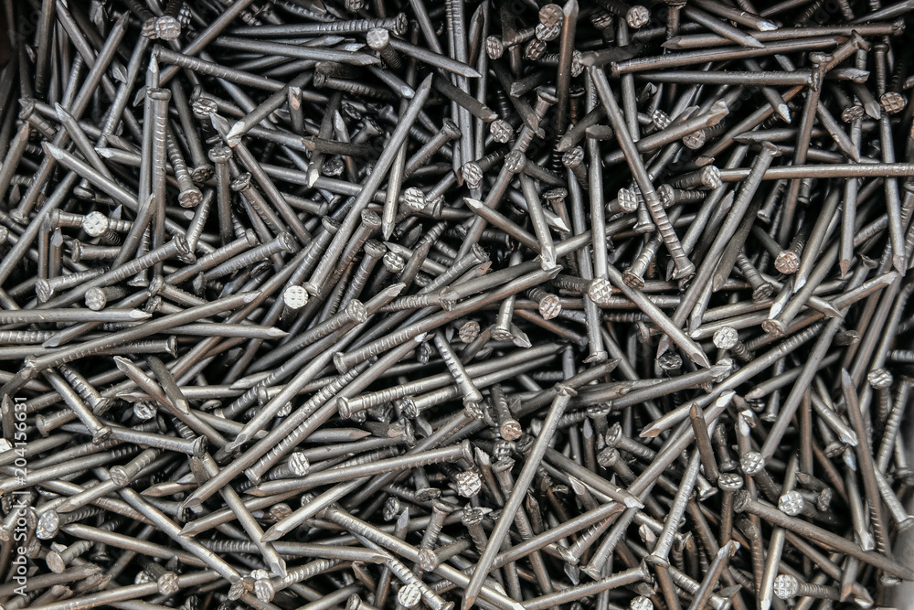 Metal steel nails in set. Fasteners for construction. Detailed background.
