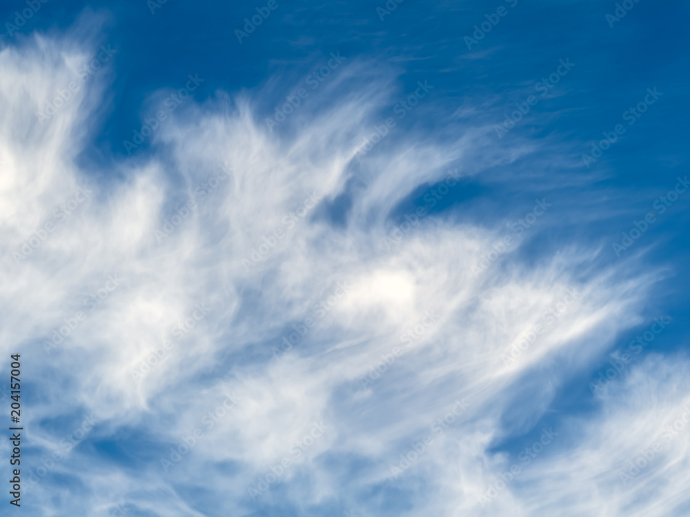 Wispy cloudscape against a blue sky.