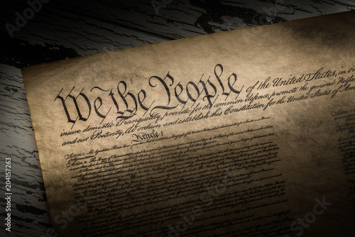 A copy of the Constitution of the United Sates of American on a wooden background photo