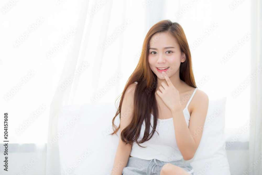 Portrait beautiful young asian woman sitting and smile the window at bedroom while wake up with sunrise at morning, lifestyle and relax concept. Portrait beautiful young asian woman sitting and smile the window at bedroom while wake up with sunrise at morning, lifestyle and relax concept.