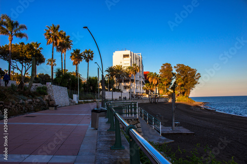 Promenade. The promenade of Estepona in front of the sunset. Malaga province  Andalusia  Spain. Picture taken     4 may 2018.
