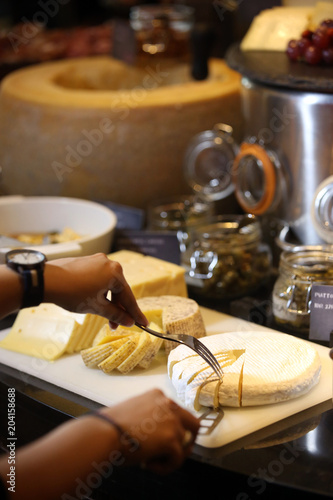 Assorted cheese on a wooden board, cheese tasting concept