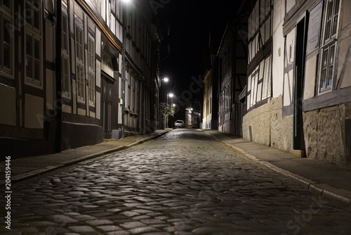 Tiny street with old nordic style houses at night in the town of Goslar  Germany in the Harz region.