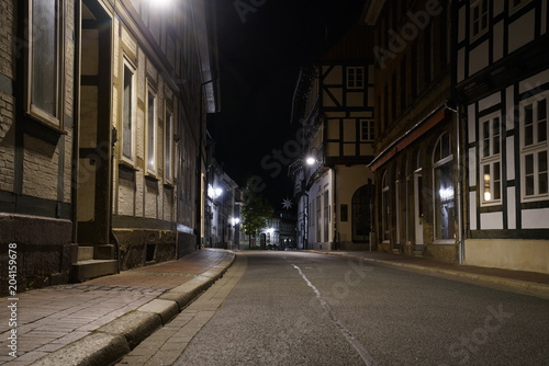  Tiny street with old nordic style houses at night in the town of Goslar, Germany in the Harz region.