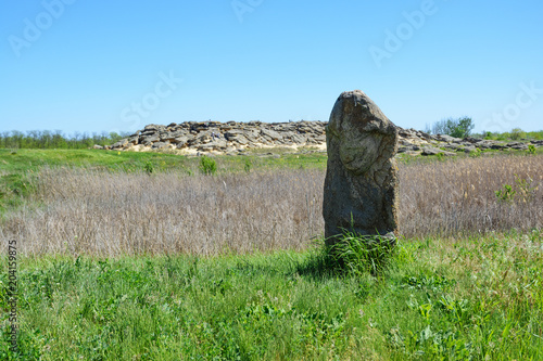 Ancient statue of Polovtsian stone woman or boundary stone in the steppe near the ..archaeological reserve 