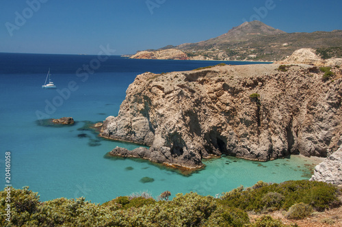 Yachting near the cliffs of Tsigrado beach at Milos island in Greece