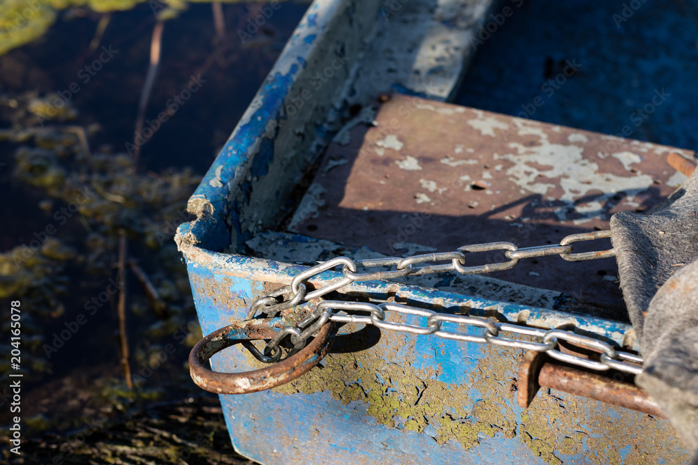 Chain for securing a fishing boat against theft. Moored fishing boat.