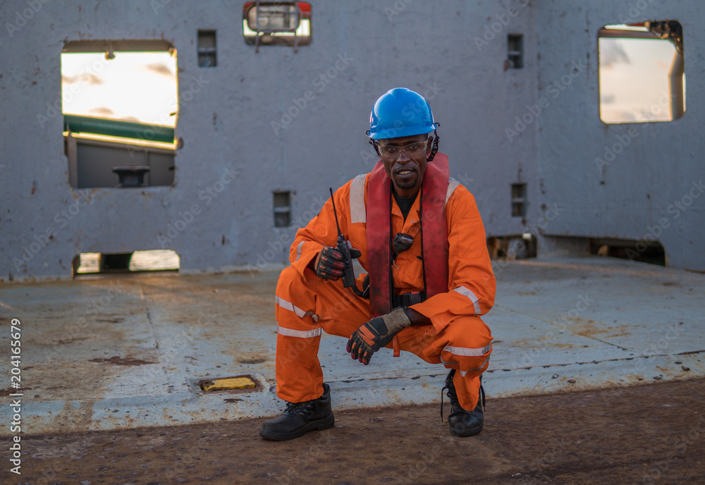 rating Seaman AB or Bosun on deck of vessel or ship , wearing PPE