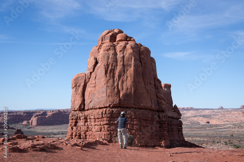 Man taking a photo of a rock