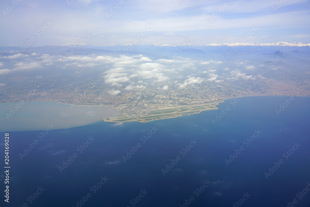 Aerial view of the Nice area, the Baie des Anges and the French Riviera on the Mediterranean Sea with the Nice Cote d'Azur Airport (NCE) in the foreground