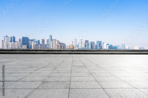 empty marble floor with panoramic city skyline © THINK b