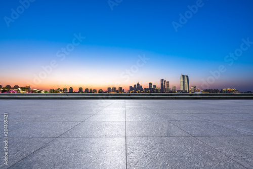 empty marble floor with panoramic city skyline