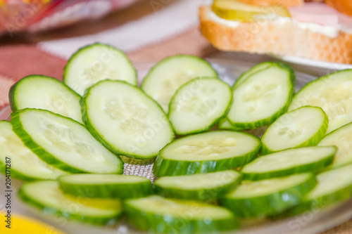 Salted cucumbers. Slices of cucumbers on the table. Sliced cucumber.
