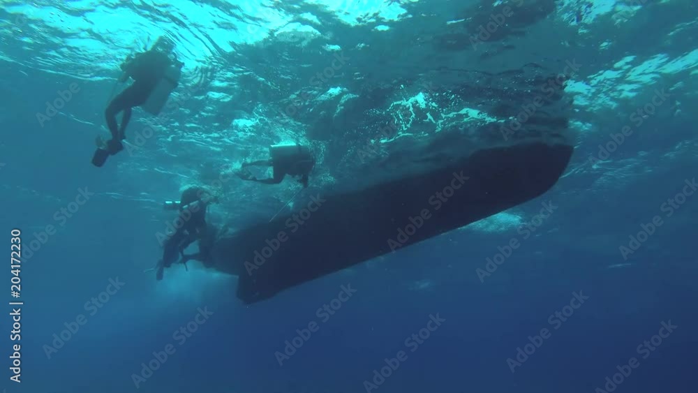 Group scuba divers swim to the ladder diving boat, Indian Ocean, Fuvahmulah island, Maldives
Group scuba divers swim to the ladder diving boat, Indian Ocean, Fuvahmulah island, Maldives