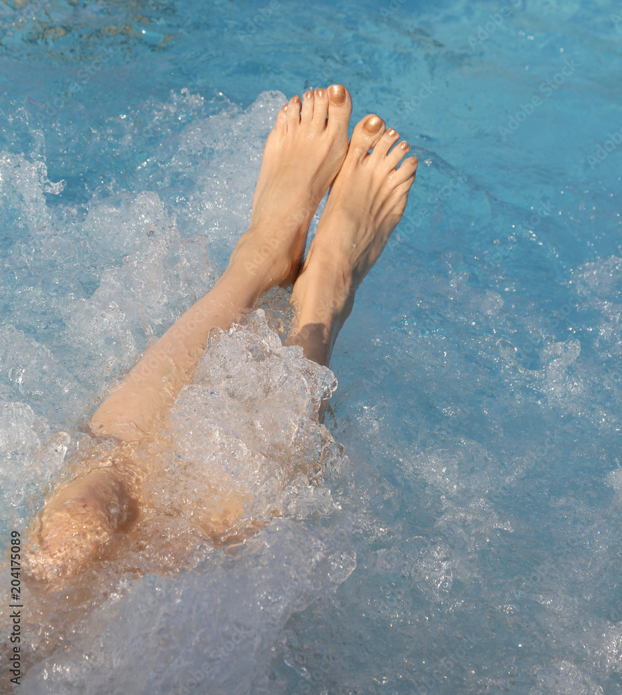 feet during the whirlpool therapy in the spa pool