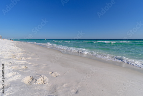 Gulf of Mexico emerald green and blue water washing on shore in waves