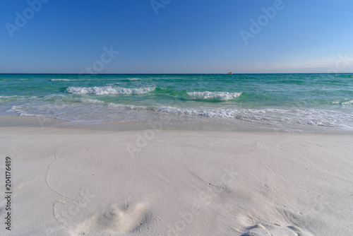 Gulf of Mexico emerald green and blue water washing on shore in waves