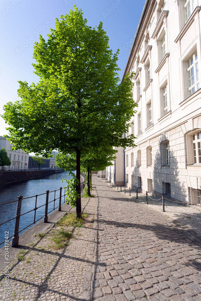 Quiet street in historic district, along a river, on a spring afternoon - Berlin