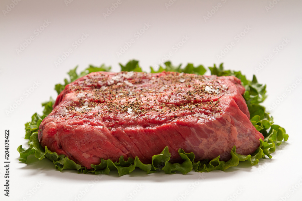 Raw Beef Roast On White Background with Lettuce Raw Beef Roast On White Background with Lettuce