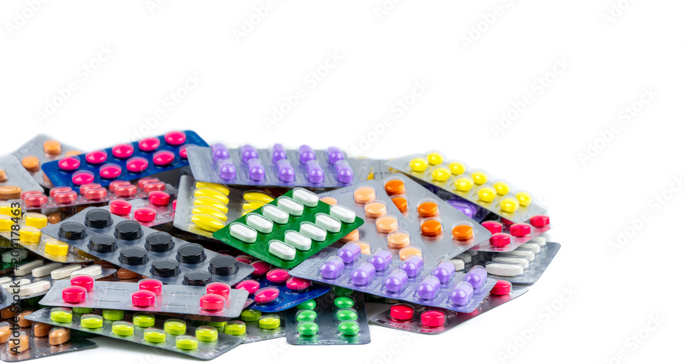 Pile of beautiful and colorful pills in blister pack isolated on white background. Health and medicine concept. Pharmaceutical packaging industry concept. Drug use with reasonable in global healthcare