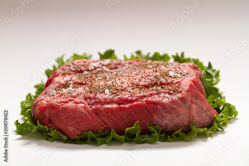 Raw Beef Roast On White Background with Lettuce