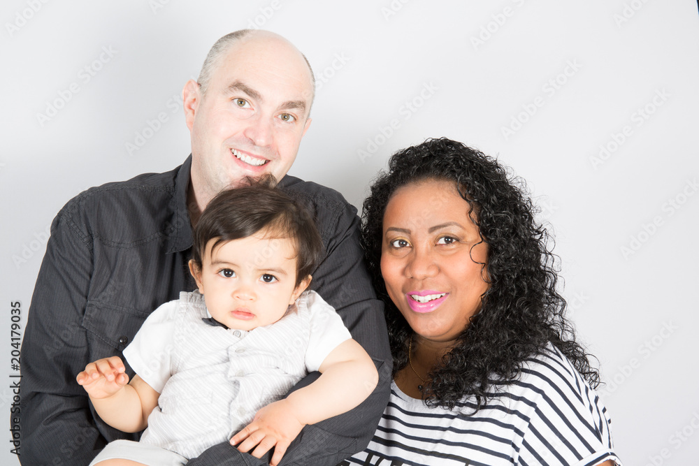 Happy mixed race family with little child boy on white background Happy mixed race family with little child boy on white background